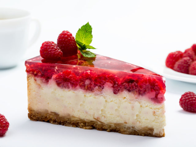 Raspberry cheesecake on white background.