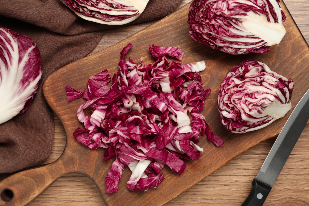 Cut,Radicchio,And,Knife,On,Wooden,Table,,Flat,Lay