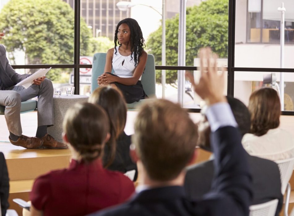 Male and female seminar speakers take question from audience