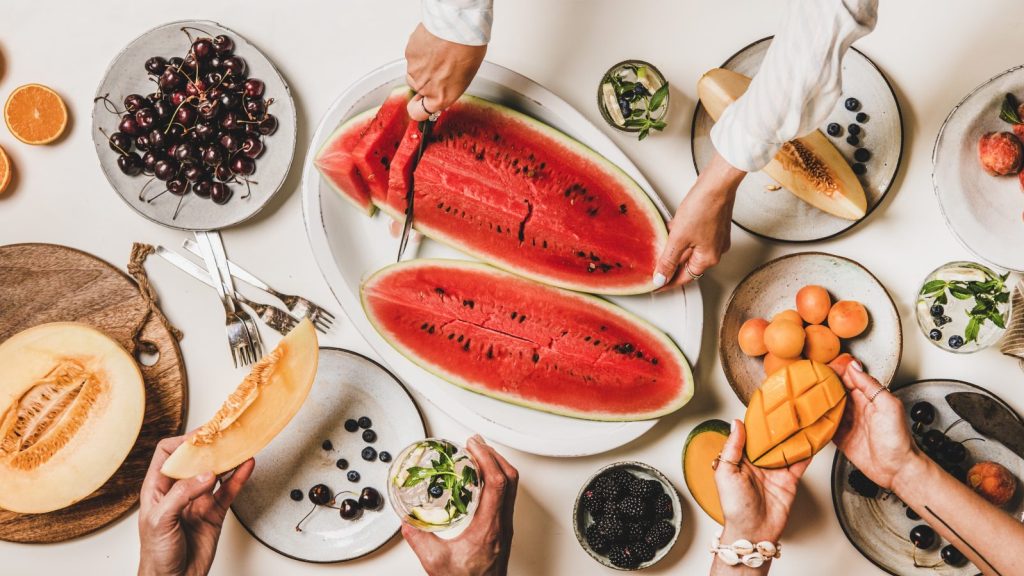 peoples-hands-holding-various-fruits-at-tropical-v-2024-10-18-05-44-17-utc