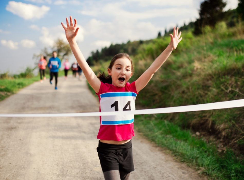 Small,Girl,Runner,Crossing,Finish,Line,In,A,Race,Competition