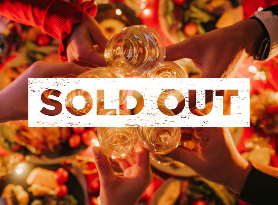 Top view of people toasting with champagne while enjoying Christmas Eve at the decorated holiday table